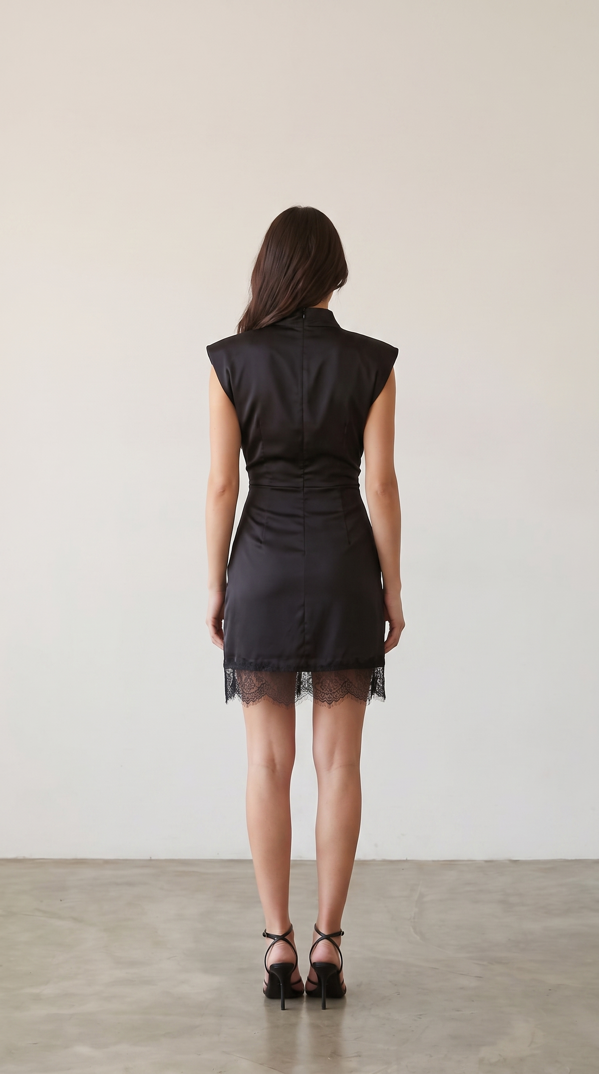 Black satin mock neck mini dress with lace hem, back view