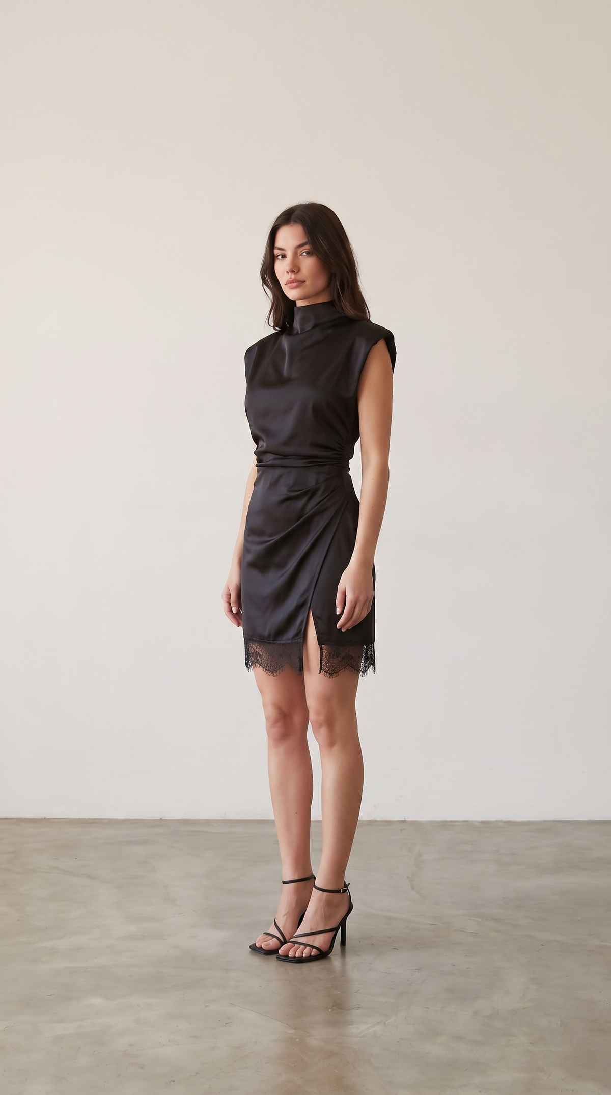 Black satin mock neck mini dress with lace hem, side view