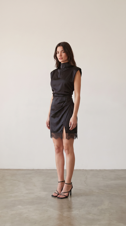 Black satin mock neck mini dress with lace hem, side view