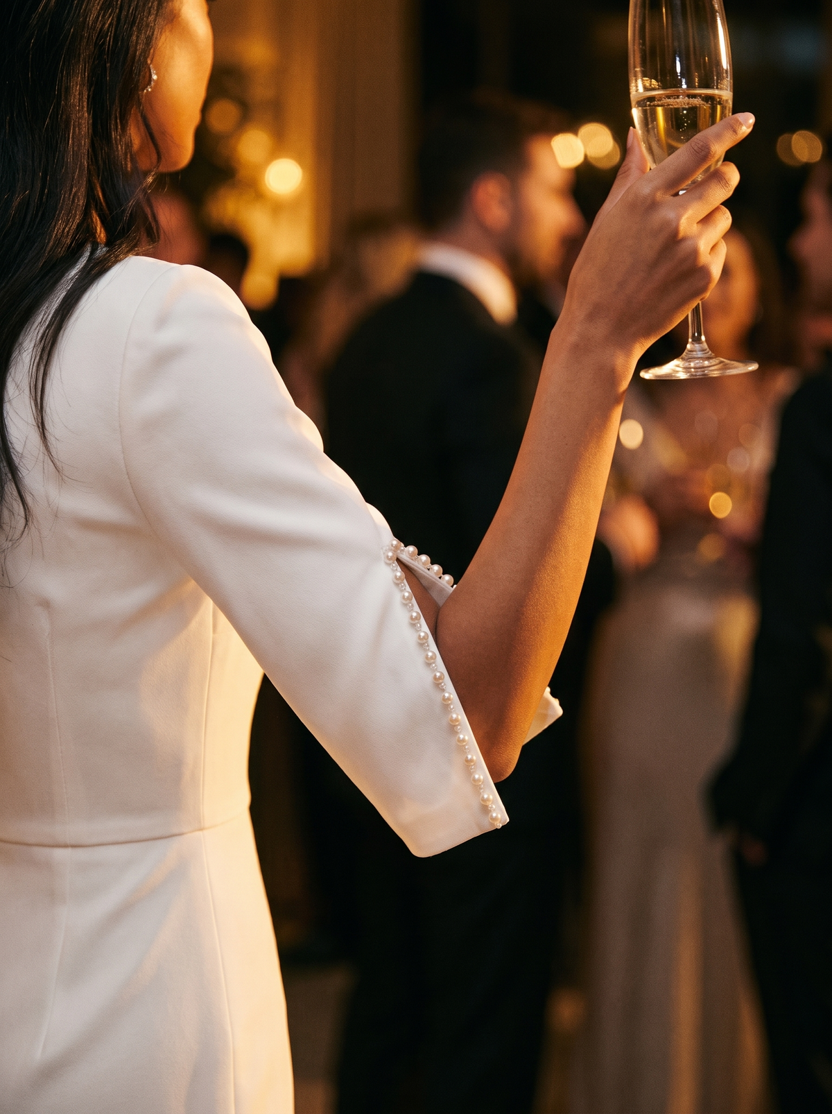 Beaded split sleeve detail catching the light at an evening event